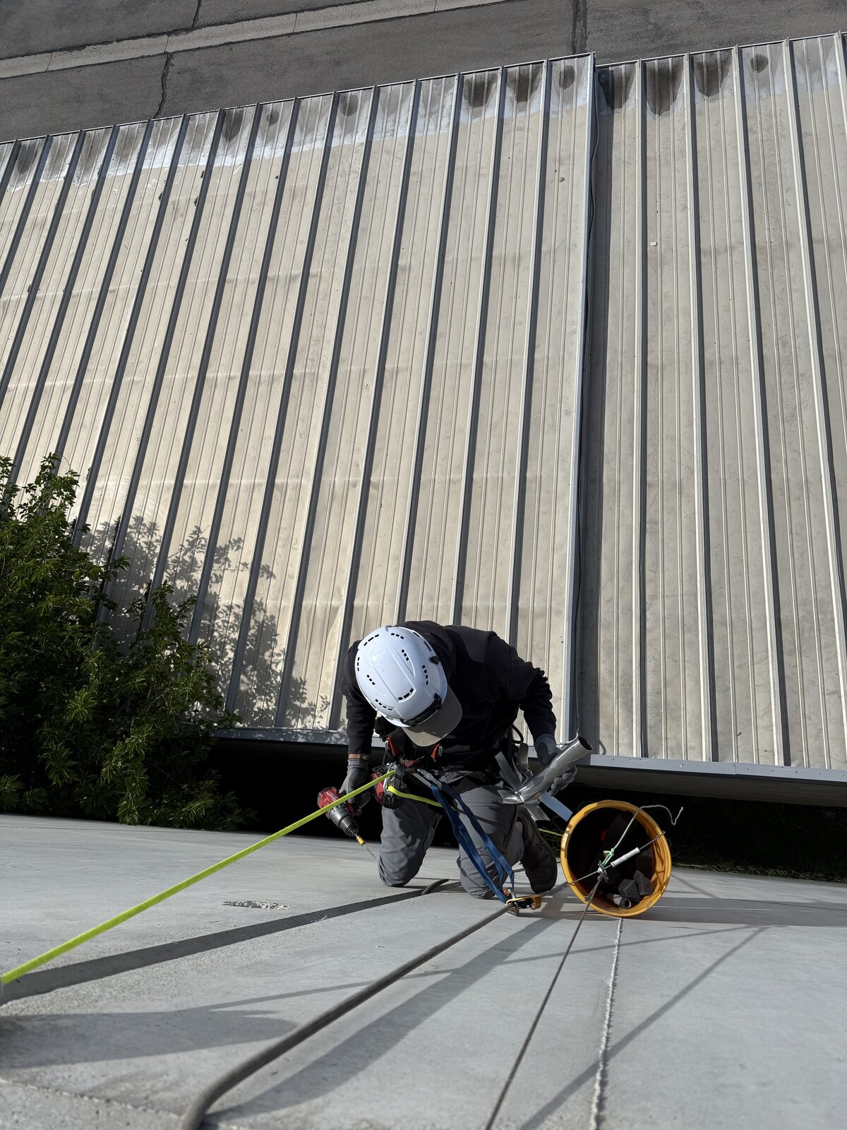 Rope-access technician preparing for upper-story exterior work